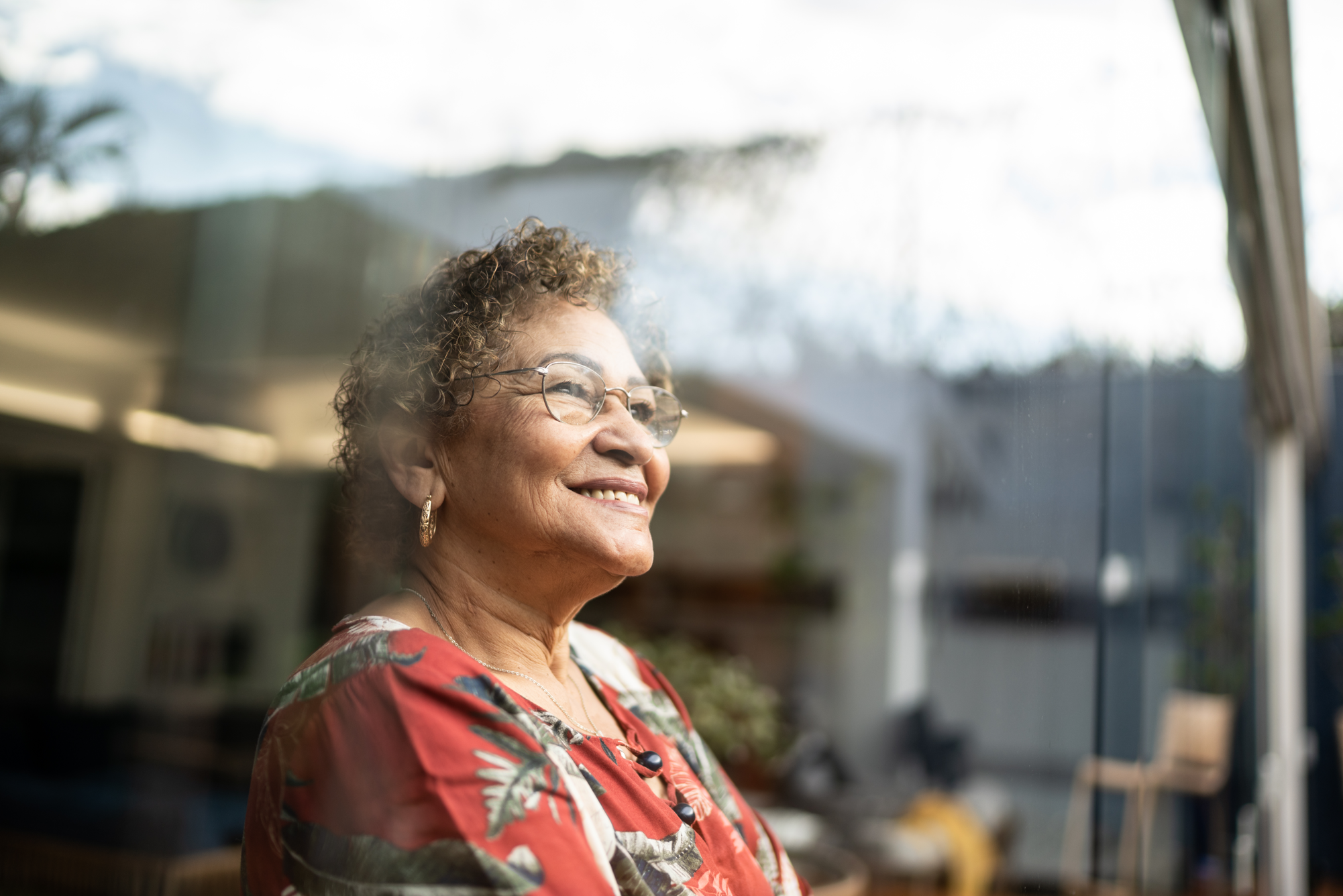 Woman looking out window smiling